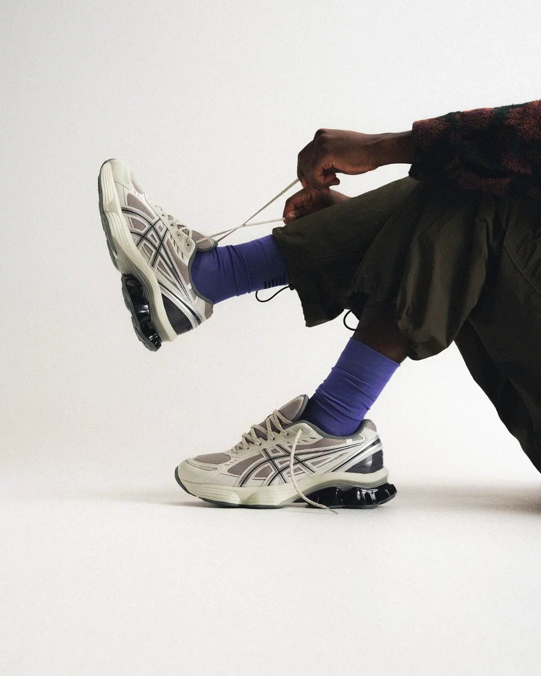 Asics Gel collection image showing the pairs in white and black worn with purple socks.
