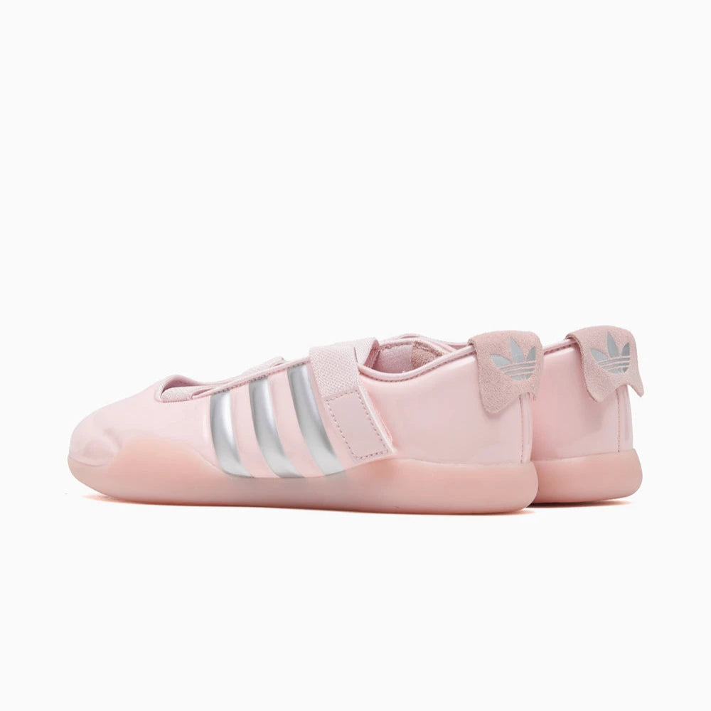 Pink Adidas taekwondo shoes with three silver stripes on a white background