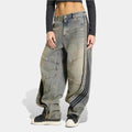 Baggy adidas jeans worn by a person on a white background