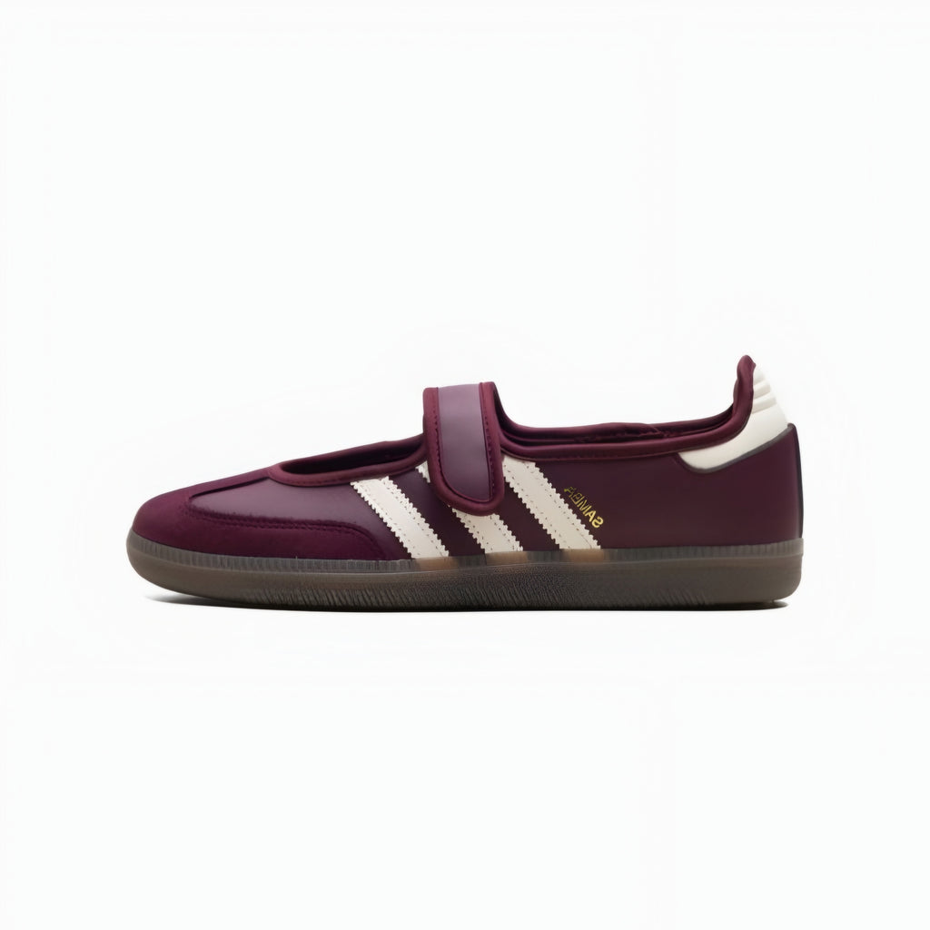 A single Adidas Samba sneaker in deep burgundy with three cream stripes, a hook-and-loop strap, and a brown gum sole, shown in profile against a white background.