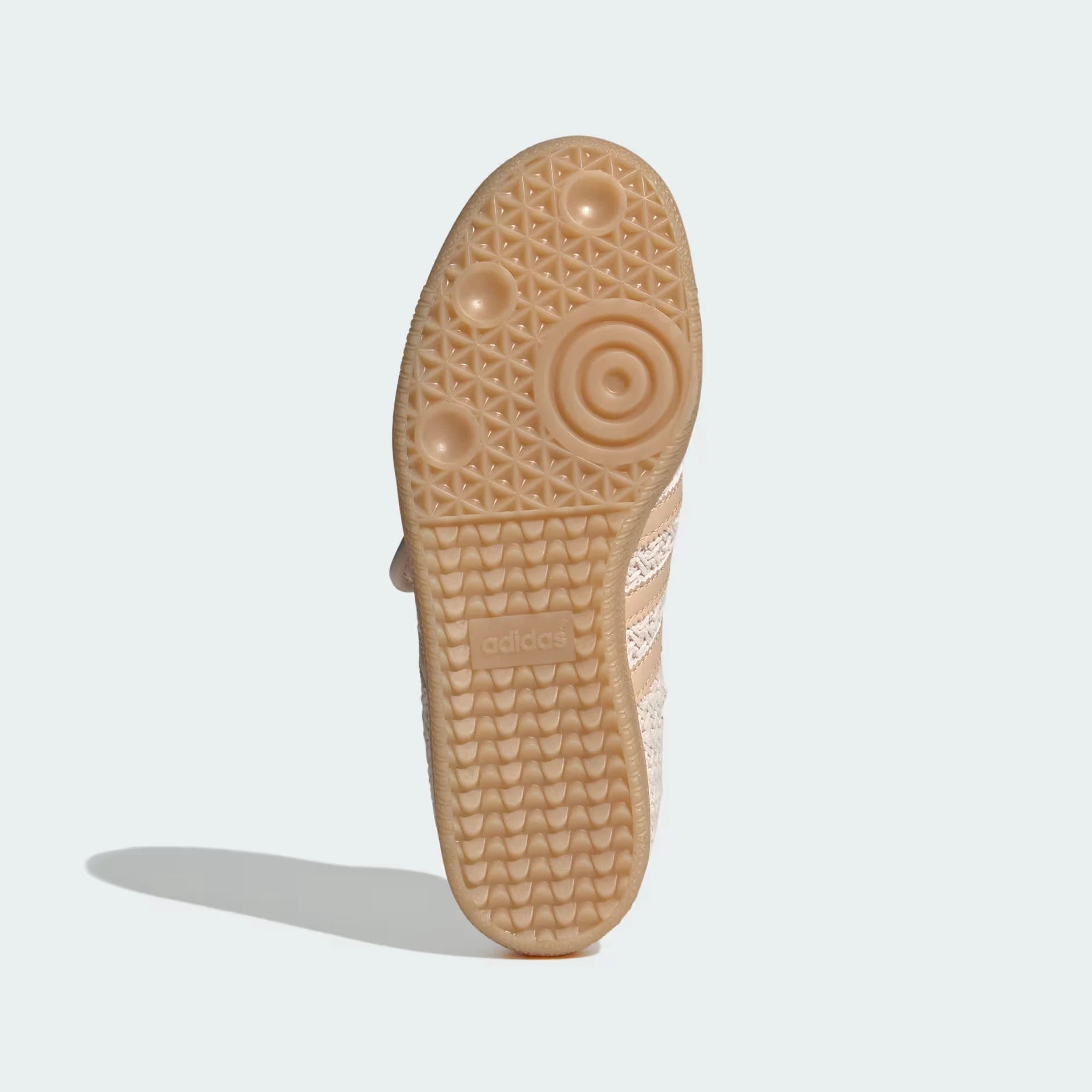 Close-up of a the adidas samba jane sole with textured pattern on a light gray background