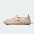 A single Adidas samba jane sneaker in a light beige and cream colorway, featuring a woven knit upper, a hook-and-loop strap closure, and a gum rubber sole, shown against a light gray background.