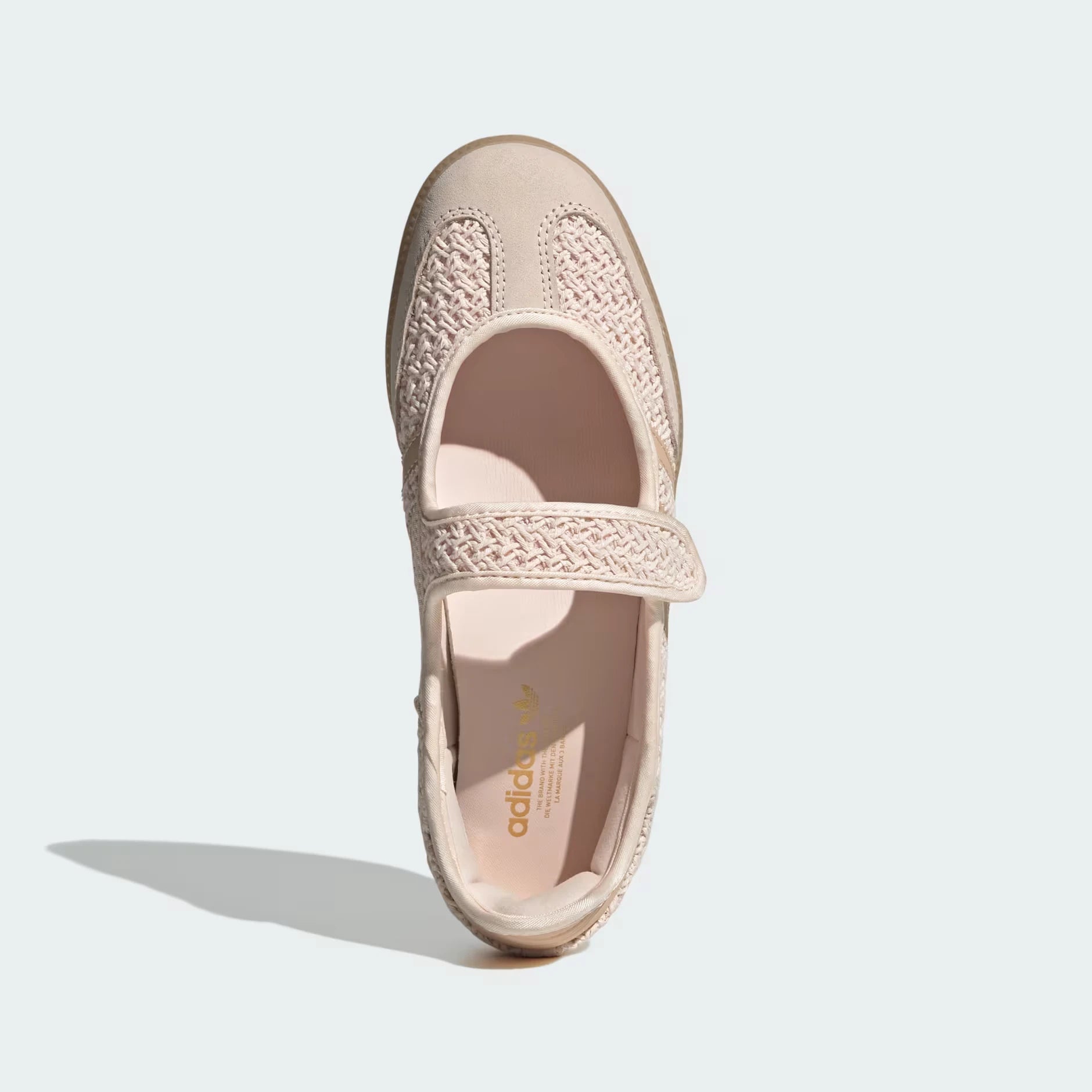 A single Adidas Mary Jane shoe in a light beige or pale blush pink color, shown from a top-down view on a light gray background.