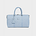 A light blue monogram duffel bag with silver hardware, featuring a top handle, a matching luggage tag, and a small silver Jordan logo on the front, set against a light gray background.