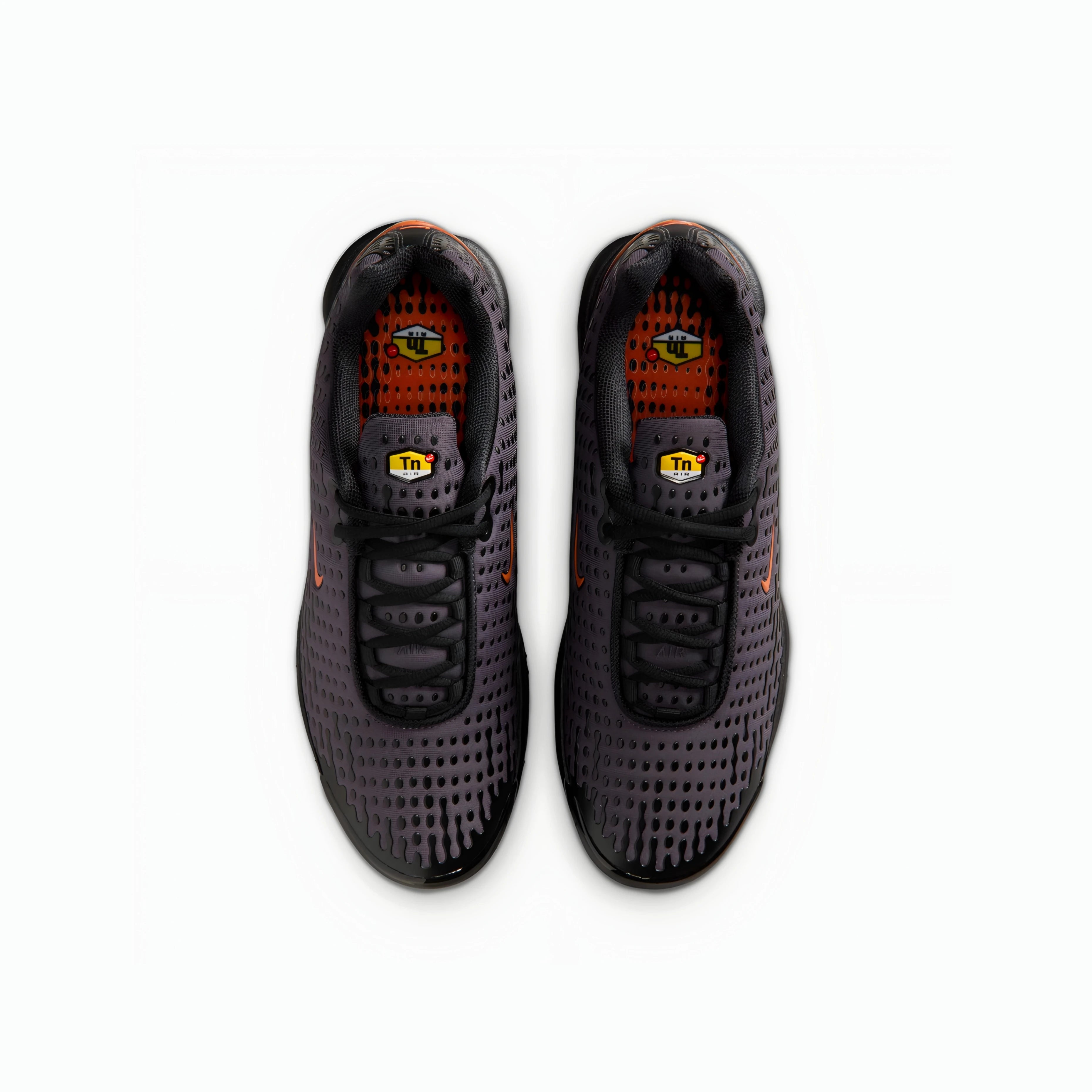 A pair of Nike Air Max plus VII running shoes in dark gray and black with orange accents, shown from a top-down view on a white background.