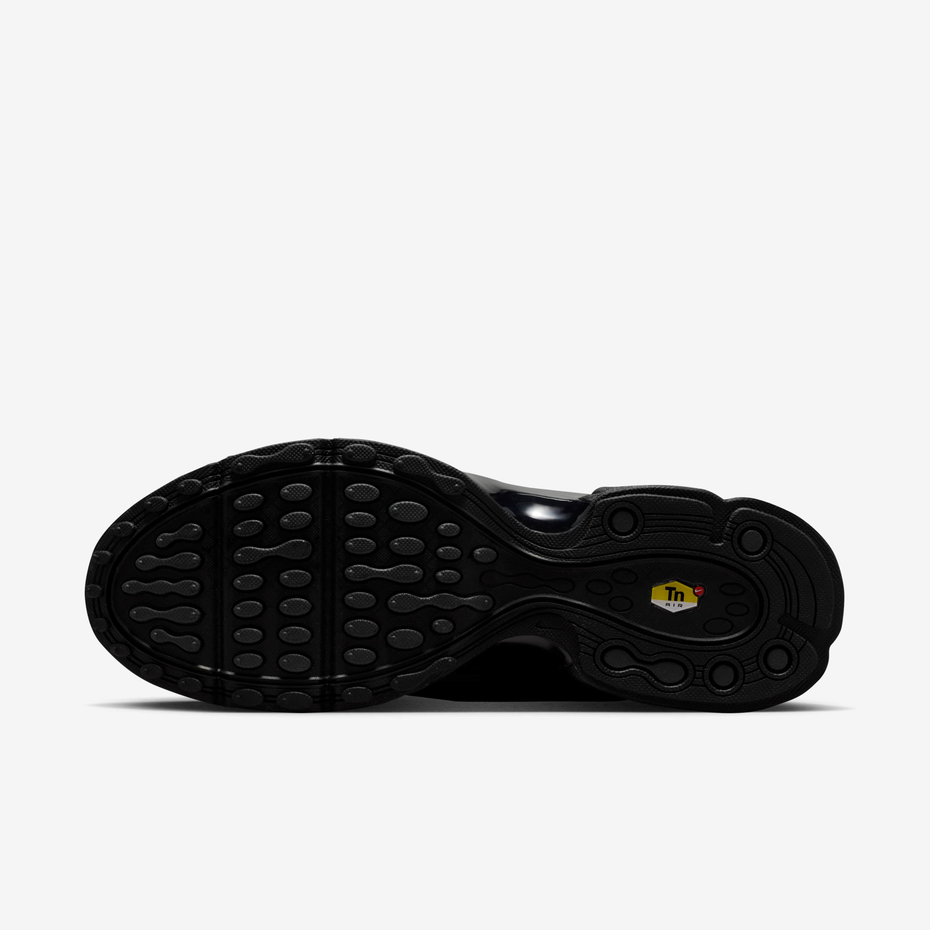 Black sneaker with white sole on a black background