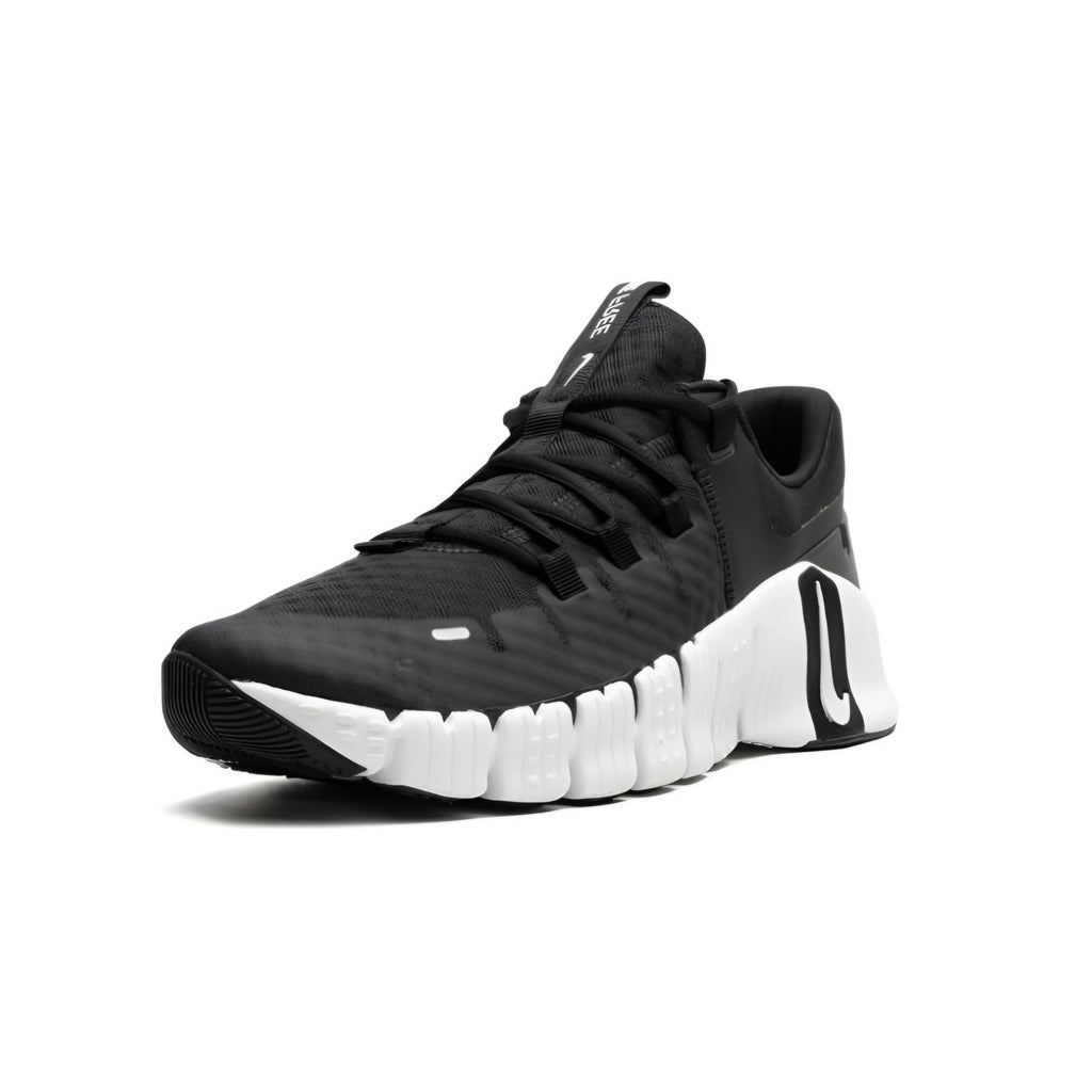 Black athletic nike shoe with white sole on a white background