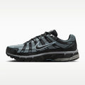 A Nike P-6000 running shoe in black and gray with a metallic silver swoosh, shown from the side profile on a light gray background.