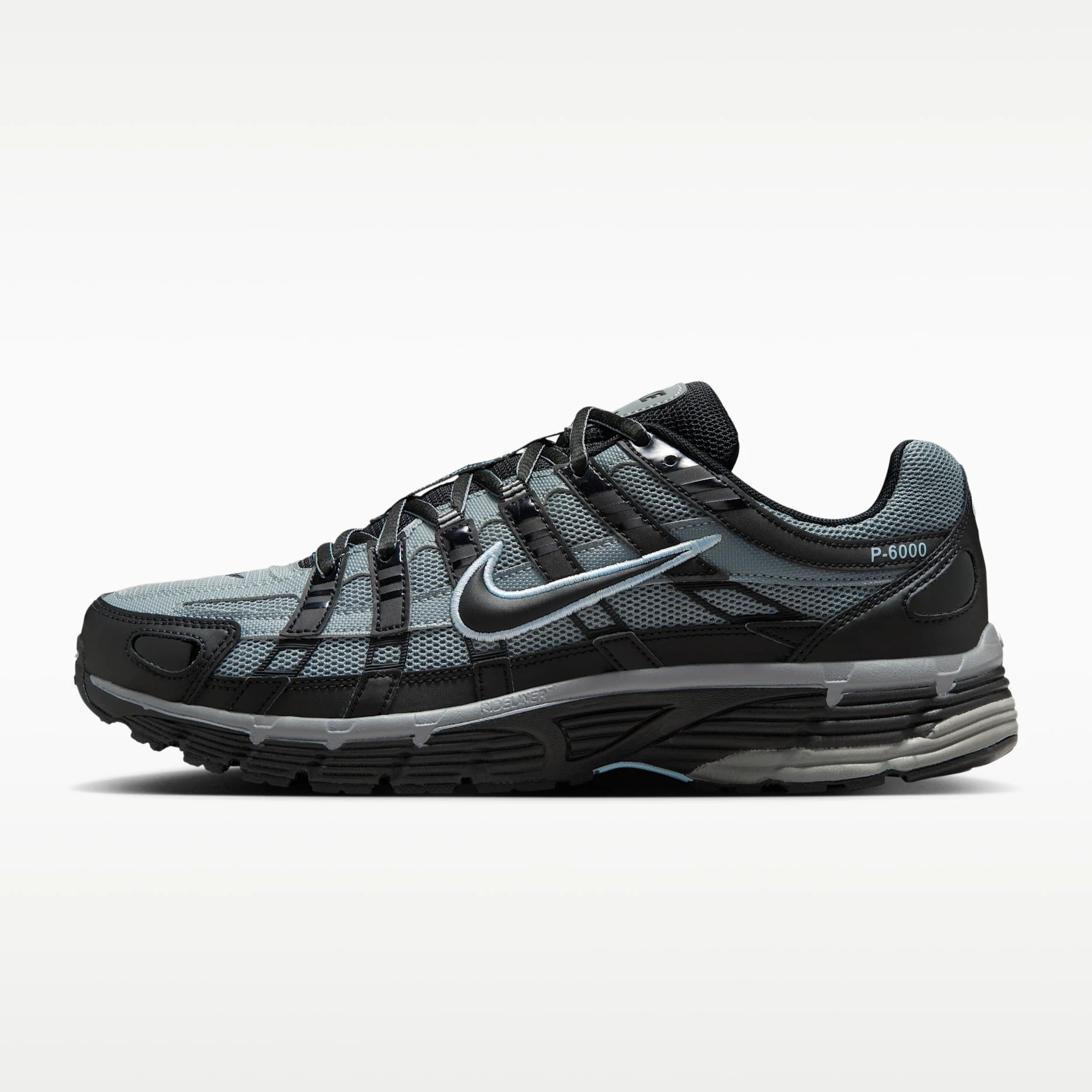 A Nike P-6000 running shoe in black and gray with a metallic silver swoosh, shown from the side profile on a light gray background.