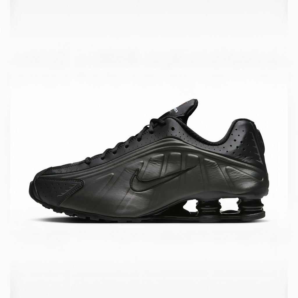 Triple Black nike shox r4 on a white background