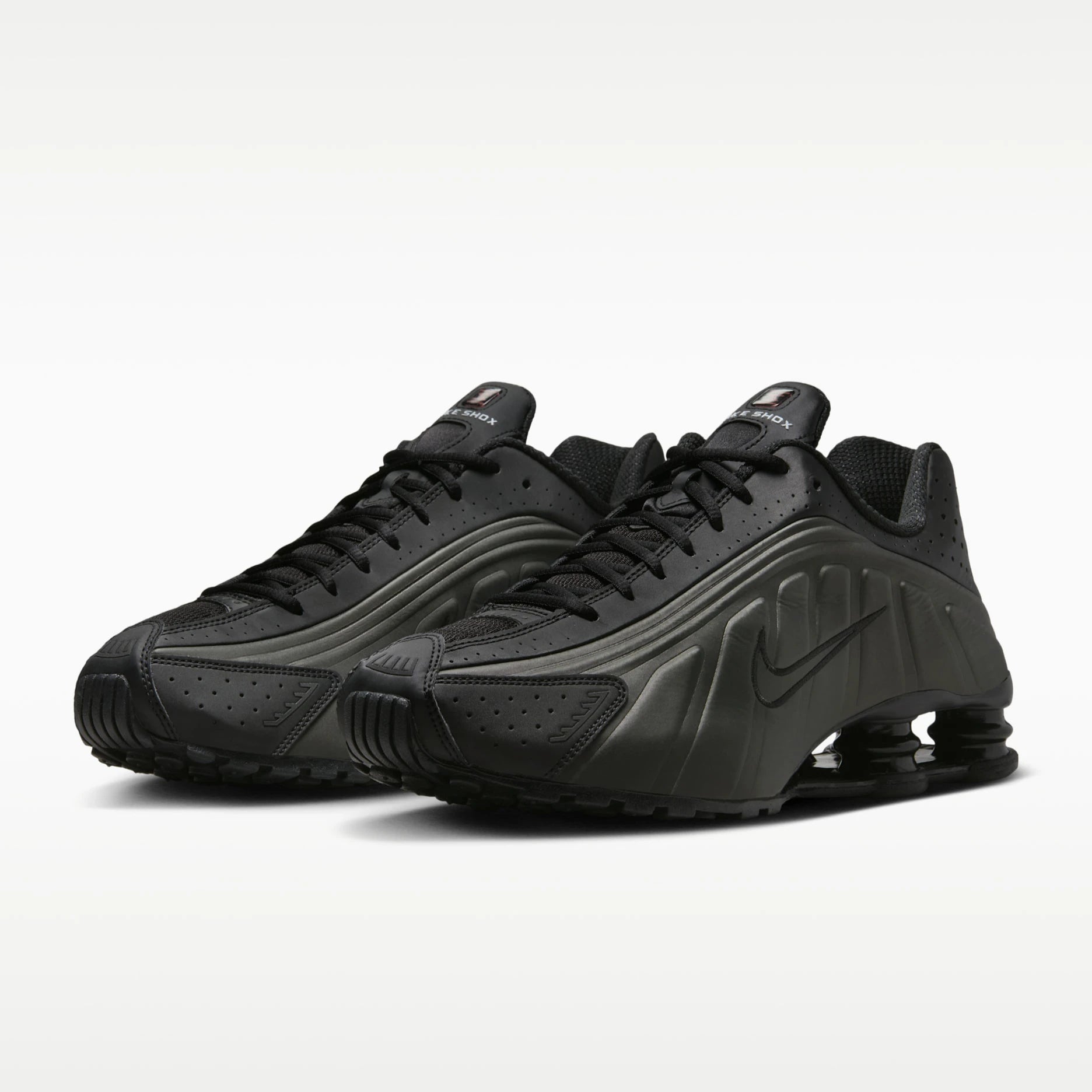 Pair of black sneakers on a white background