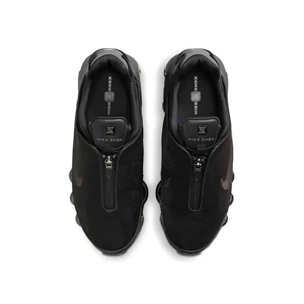 A pair of black Nike Shox zip sneakers shown from a top-down view on a white background.