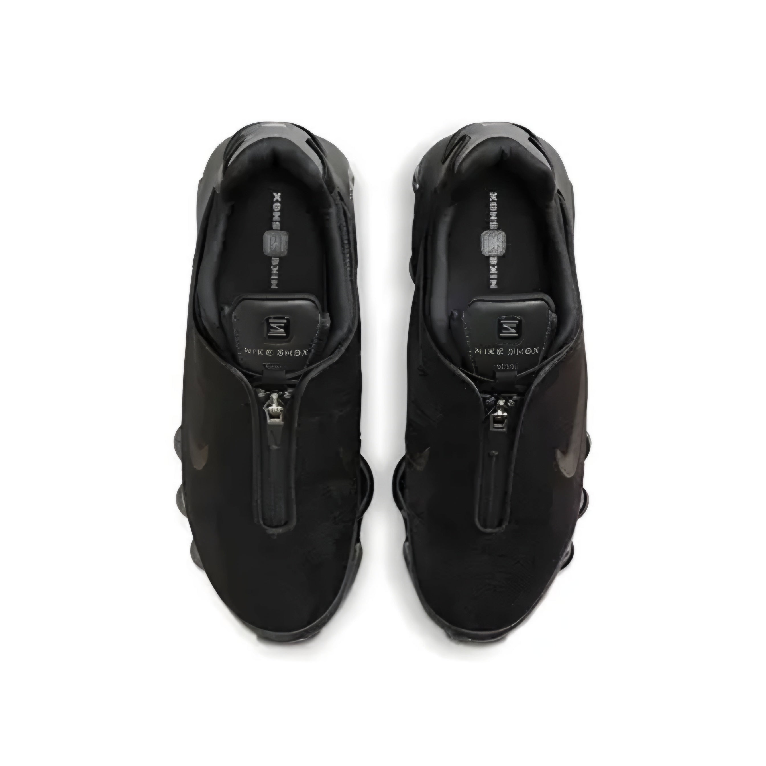 A pair of black Nike Shox zip sneakers shown from a top-down view on a white background.