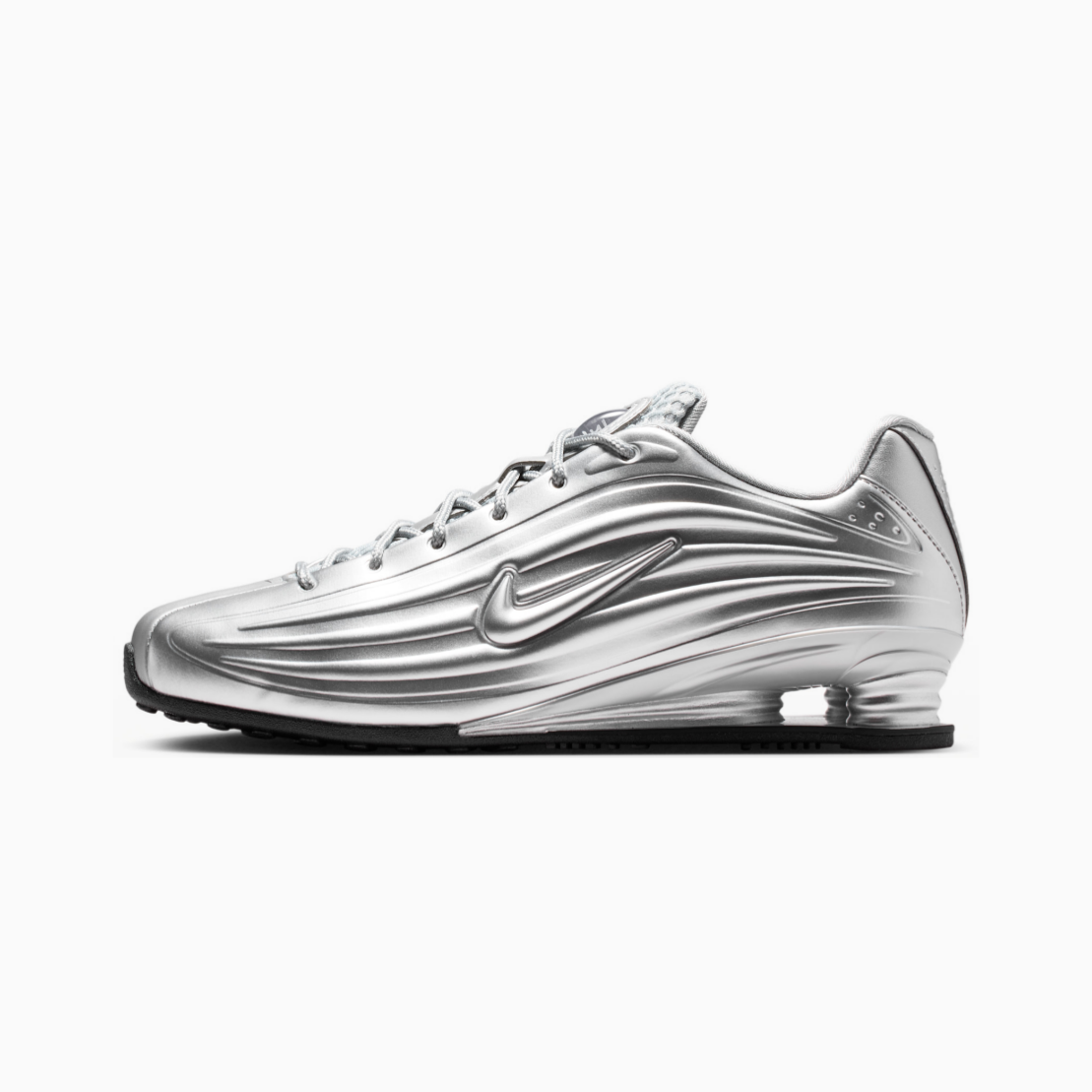 A metallic silver Nike Shox sneaker shown in a side profile view against a clean white background.