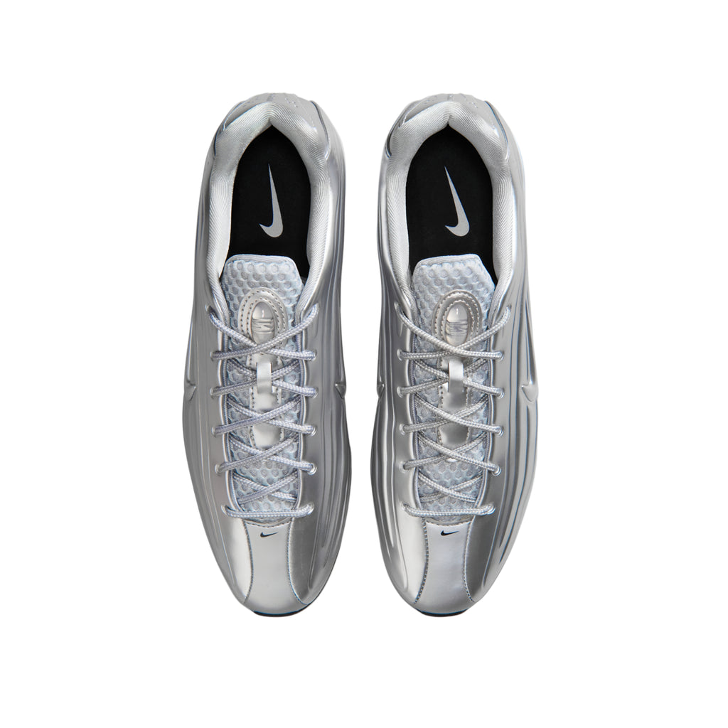 A pair of metallic silver Nike running shoes shown from a top-down view on a plain white background.