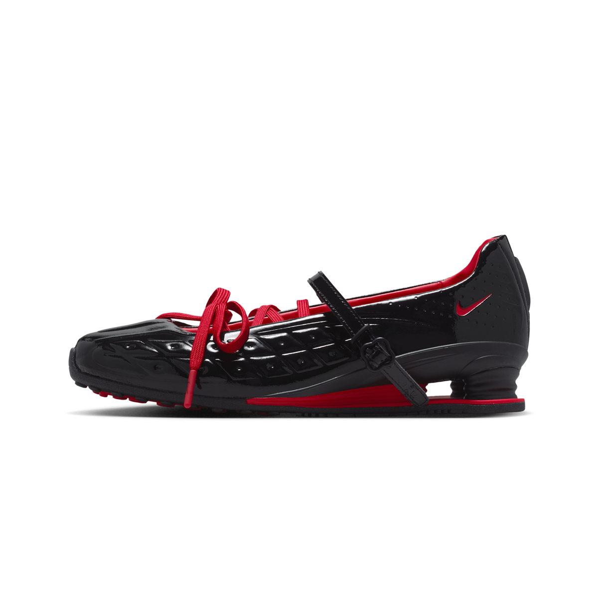A black Nike shoe with red accents, featuring a glossy textured upper, red laces, a red swoosh, and a red heel counter, shown in a side profile on a white background.