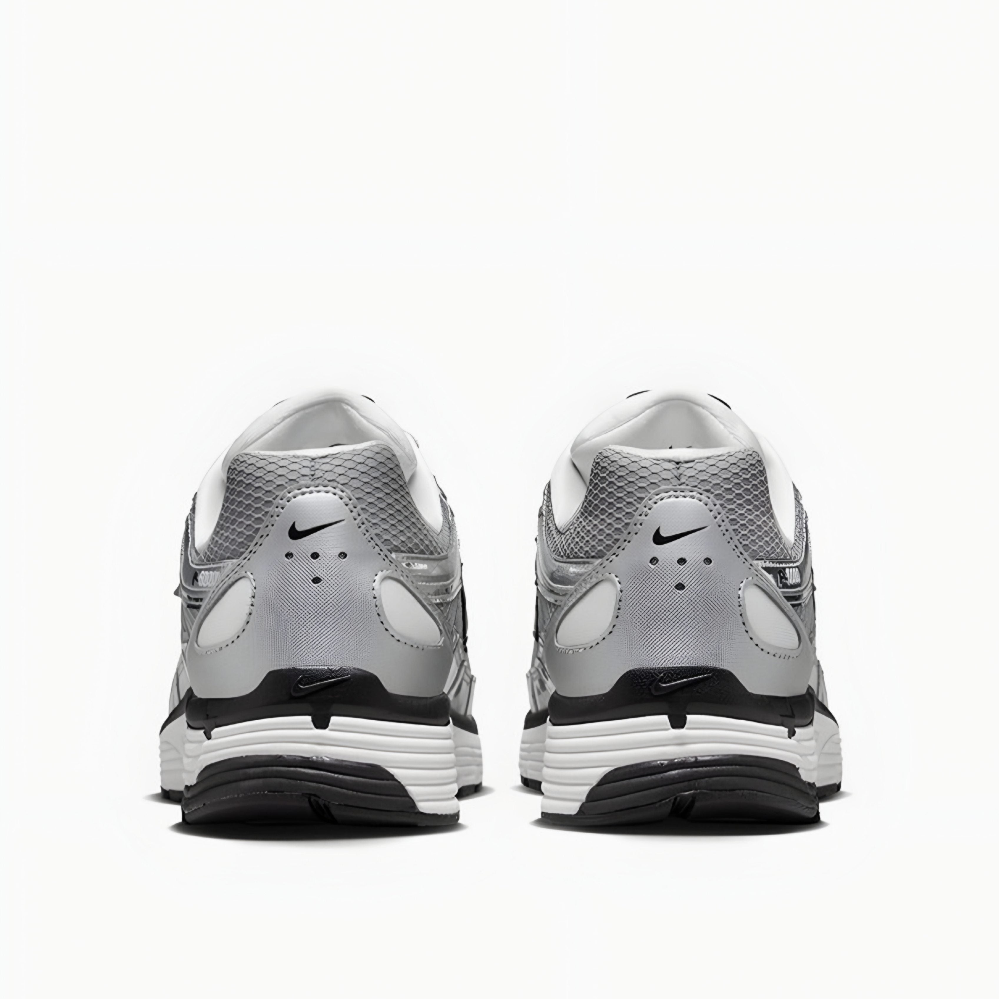 Gray and white athletic shoes with Nike logo on a white background