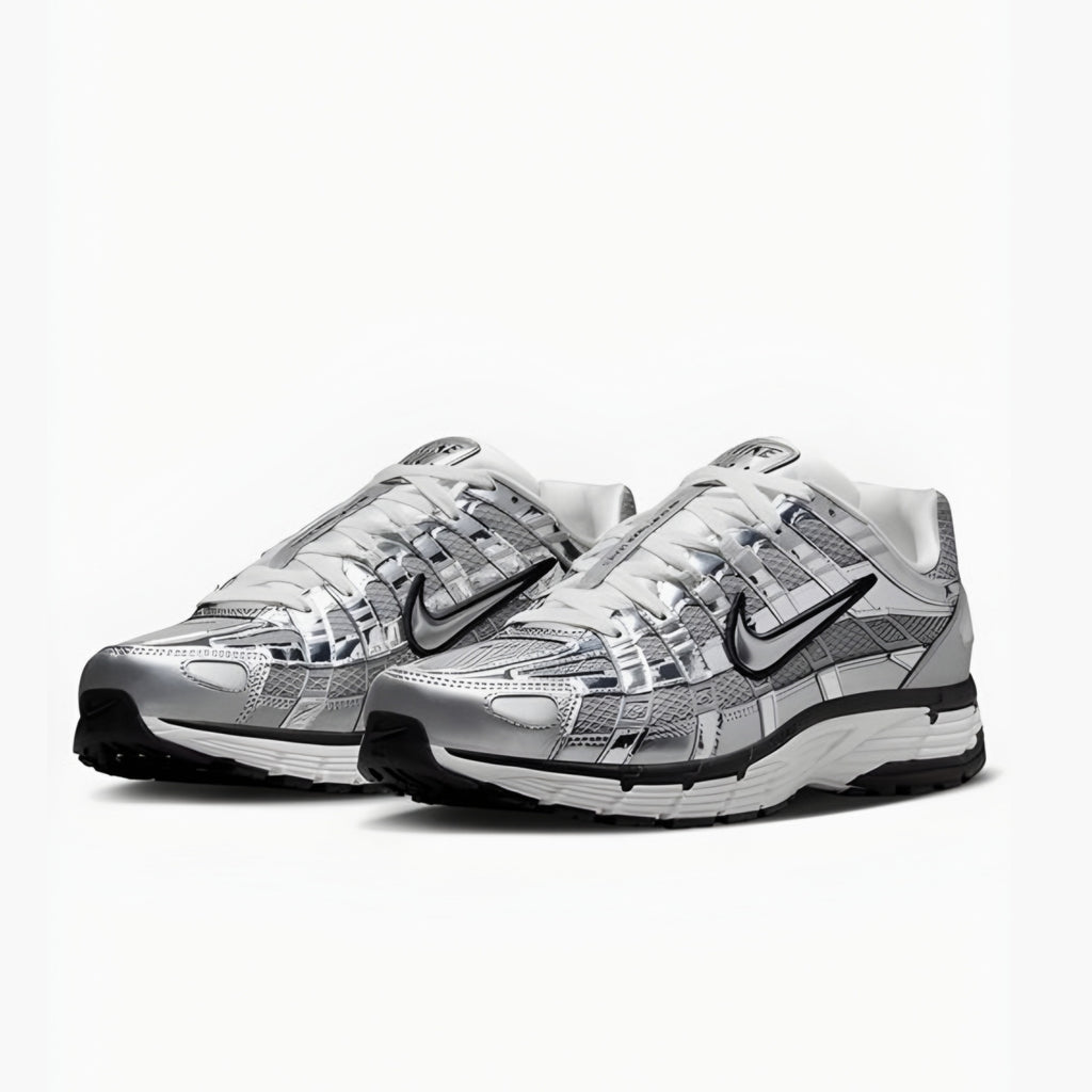 Pair of silver and black nike P6000 sneakers on a white background